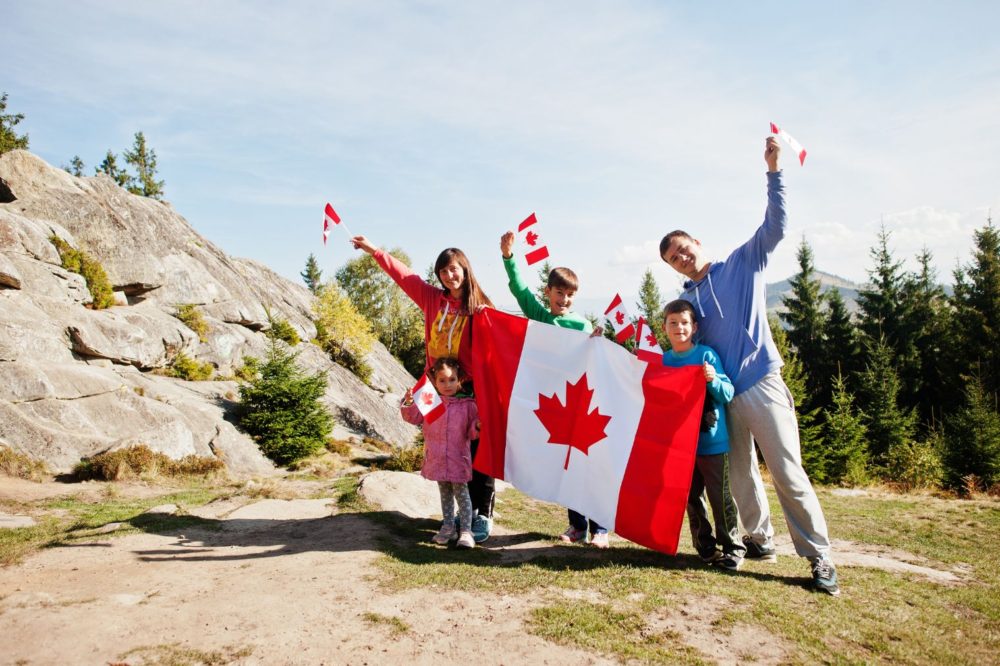 A Family hold a Canada flag